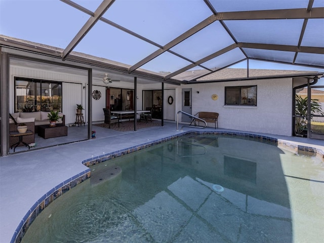 view of swimming pool with outdoor lounge area, ceiling fan, a lanai, and a patio