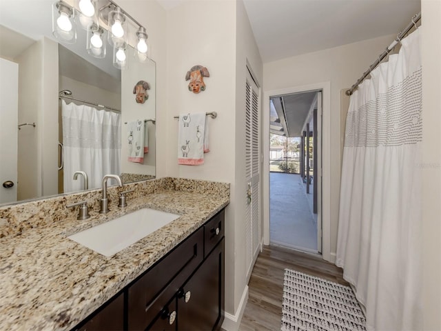 bathroom with vanity and hardwood / wood-style flooring