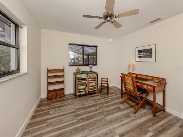 home office with hardwood / wood-style floors and ceiling fan