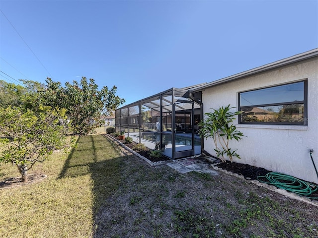 view of yard featuring glass enclosure