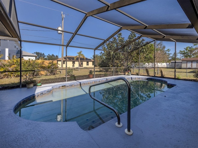 view of swimming pool with a lanai and a patio