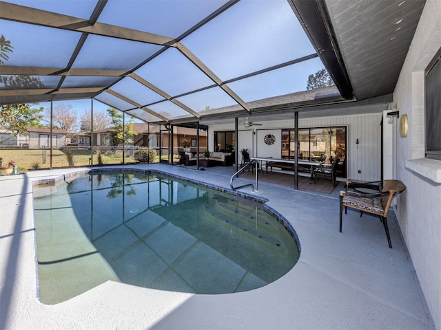 view of swimming pool with outdoor lounge area, a patio area, and glass enclosure