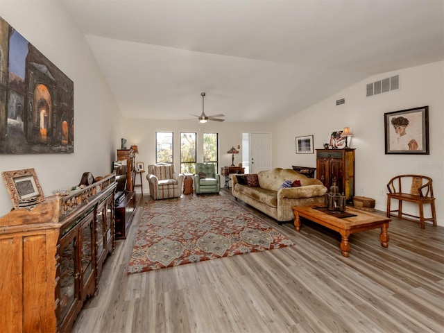 living room with hardwood / wood-style floors, vaulted ceiling, and ceiling fan