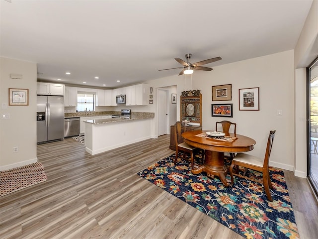 dining space featuring hardwood / wood-style flooring and ceiling fan