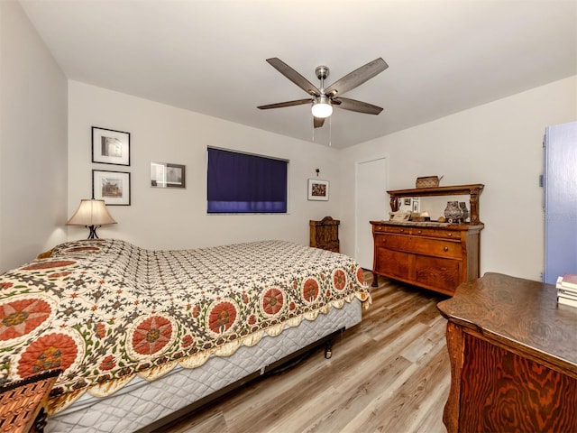 bedroom with wood-type flooring and ceiling fan