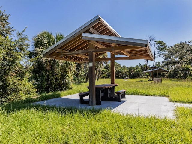 surrounding community with a gazebo and a patio area