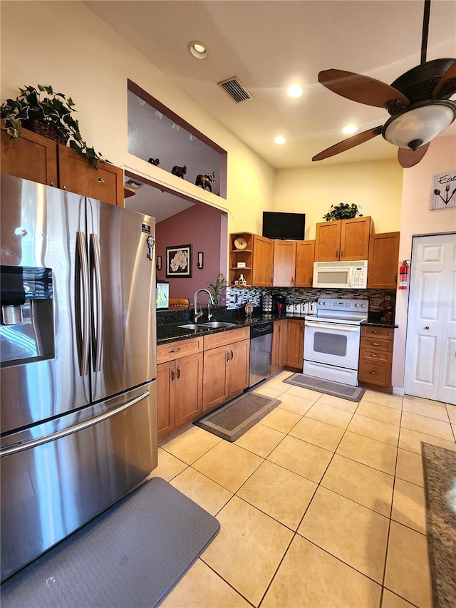 kitchen with tasteful backsplash, sink, light tile patterned floors, ceiling fan, and stainless steel appliances