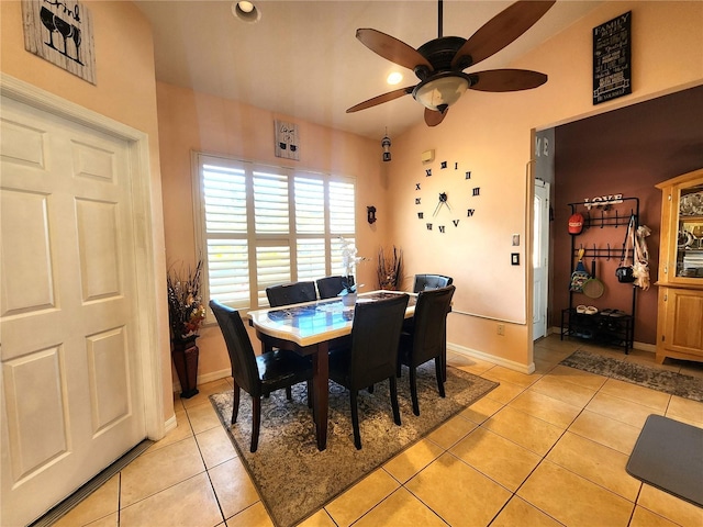 tiled dining space featuring ceiling fan