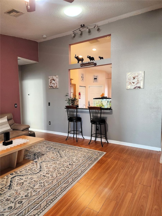 interior space featuring wood-type flooring and a textured ceiling