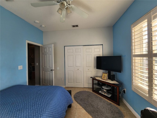 tiled bedroom with a closet and ceiling fan