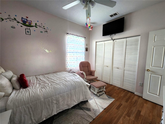 bedroom with hardwood / wood-style flooring, ceiling fan, and a closet