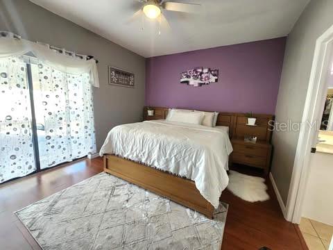 bedroom with ceiling fan and hardwood / wood-style floors