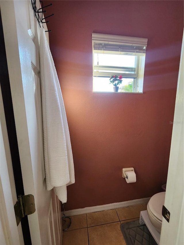 bathroom with tile patterned flooring and toilet