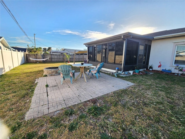 view of patio with a fire pit and a sunroom