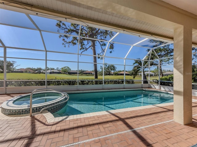 view of pool featuring an in ground hot tub, a lanai, and a patio area