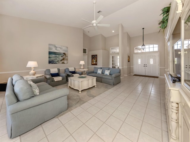 living room with light tile patterned floors, high vaulted ceiling, and ceiling fan