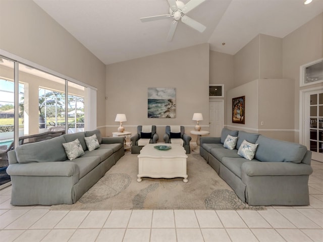 tiled living room featuring ceiling fan and high vaulted ceiling