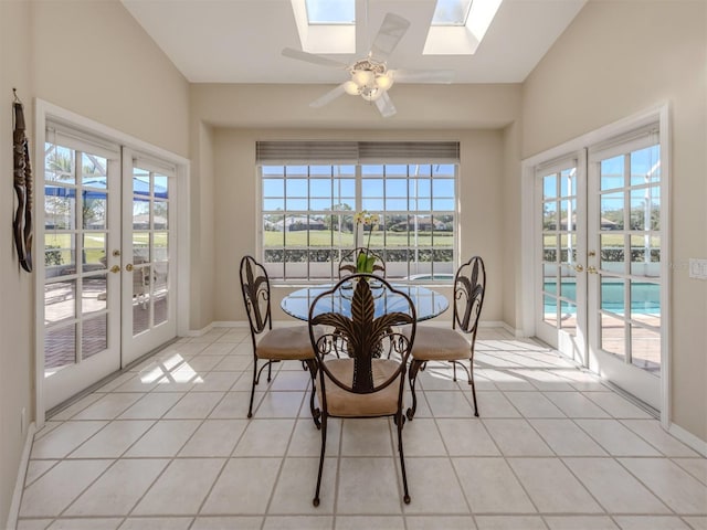 dining area featuring french doors, a skylight, light tile patterned flooring, and a wealth of natural light