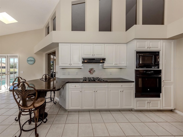 kitchen featuring white cabinetry, light tile patterned floors, and black appliances