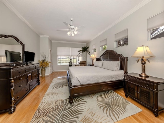 bedroom featuring crown molding, ceiling fan, and light wood-type flooring