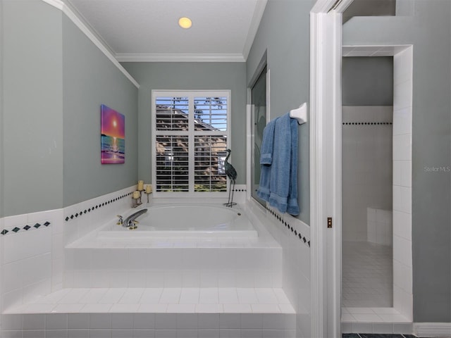 bathroom with tiled tub and crown molding