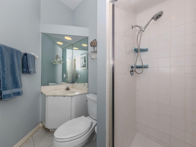 bathroom with vanity, a tile shower, tile patterned floors, and toilet