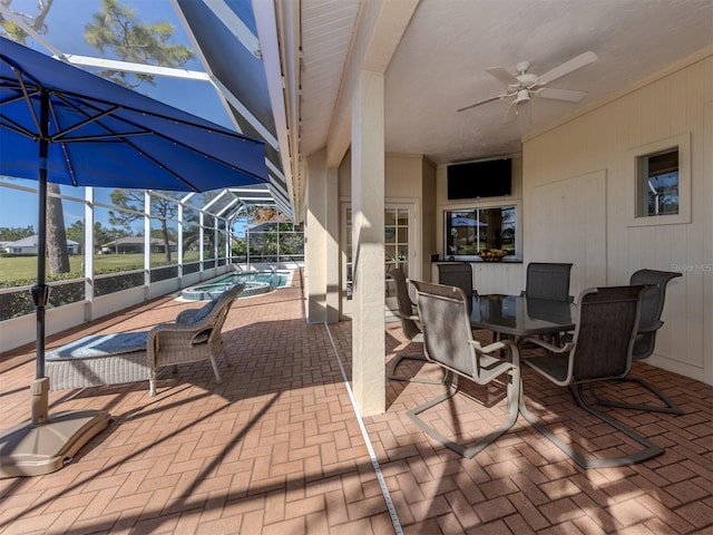 view of patio / terrace featuring a lanai and ceiling fan