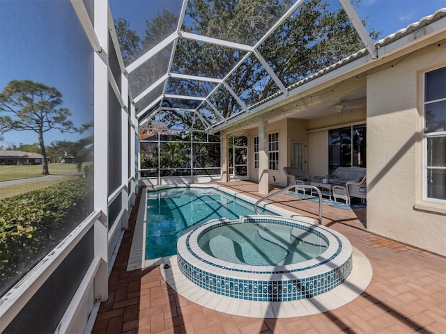 view of swimming pool featuring an in ground hot tub, ceiling fan, a patio area, and glass enclosure