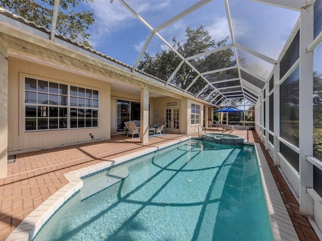 view of swimming pool featuring french doors, a patio, and glass enclosure