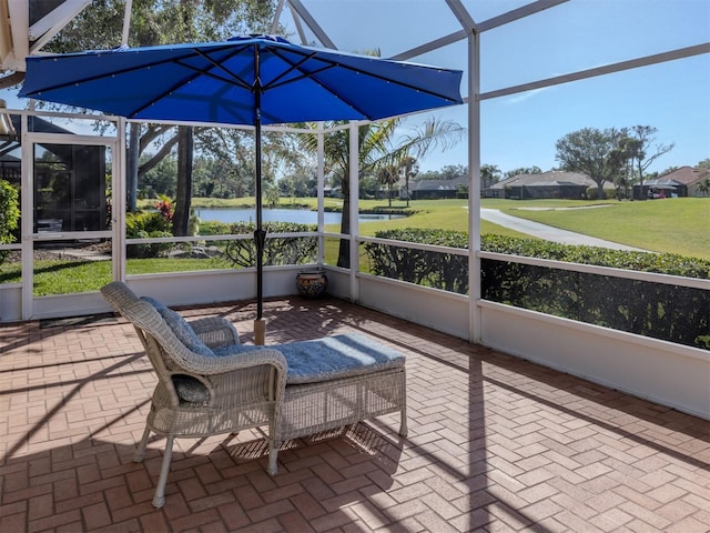 unfurnished sunroom featuring a water view