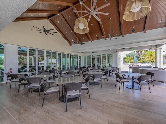 dining space featuring vaulted ceiling with beams, wooden ceiling, ceiling fan, and light hardwood / wood-style flooring