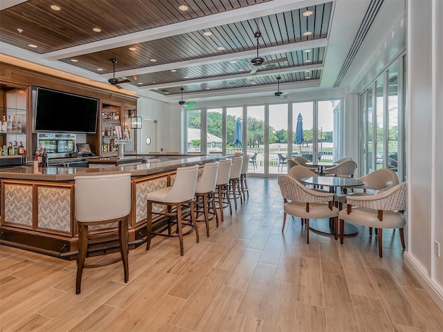 bar with beam ceiling, wooden ceiling, ceiling fan, and light hardwood / wood-style floors