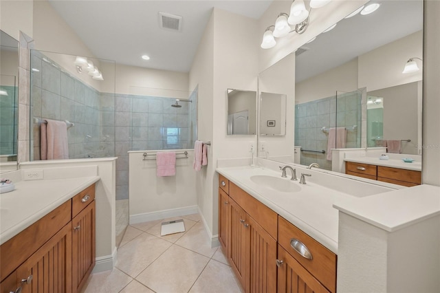 bathroom with vanity, tile patterned floors, and tiled shower