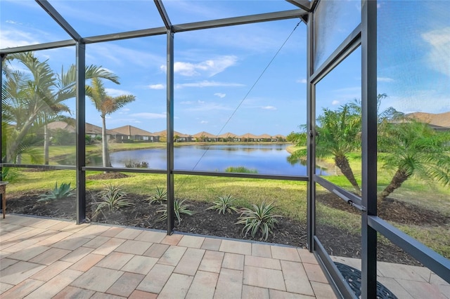 unfurnished sunroom featuring a water view