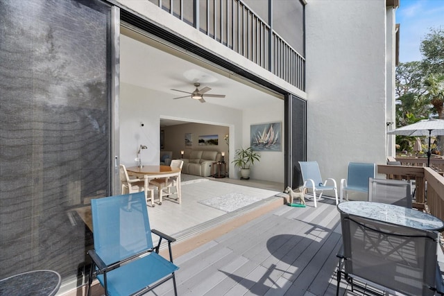 wooden deck featuring ceiling fan