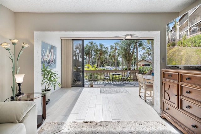 entryway featuring ceiling fan and a textured ceiling