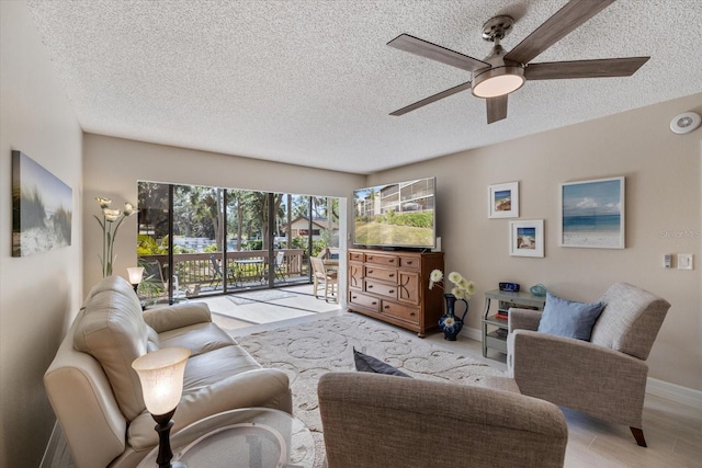 living room with a textured ceiling and ceiling fan