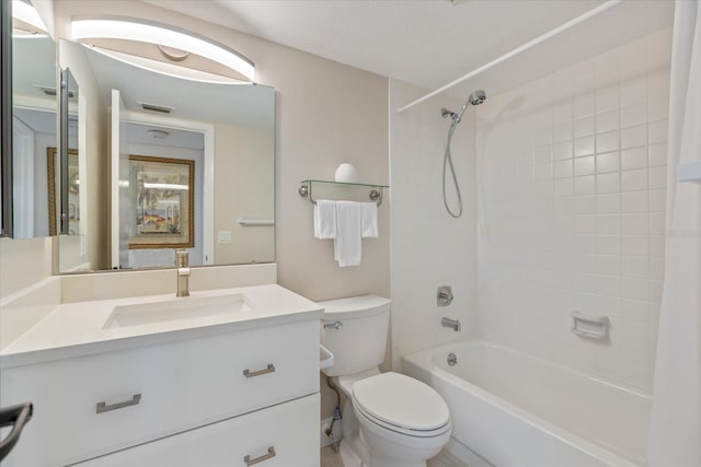 full bathroom with tiled shower / bath combo, vanity, and toilet