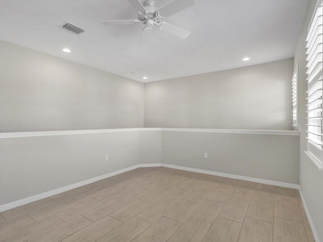 empty room with ceiling fan and light hardwood / wood-style flooring