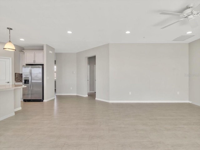 unfurnished living room featuring ceiling fan