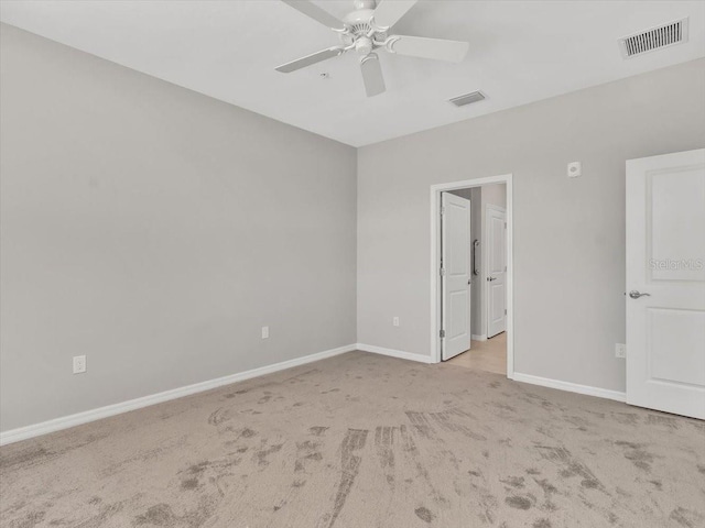 carpeted spare room featuring ceiling fan