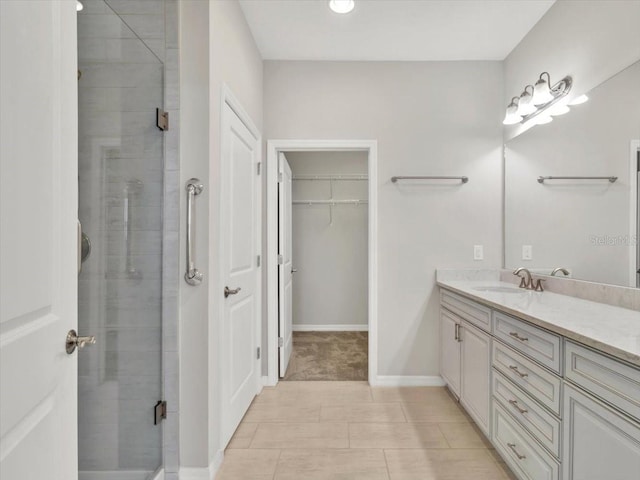 bathroom featuring vanity, tile patterned floors, and walk in shower