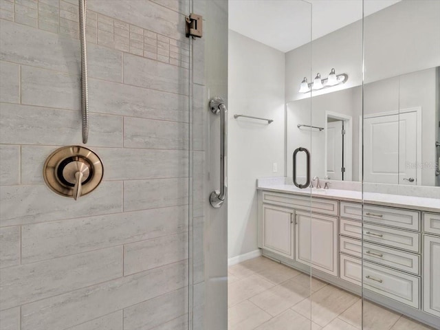 bathroom featuring vanity, tile patterned flooring, and walk in shower