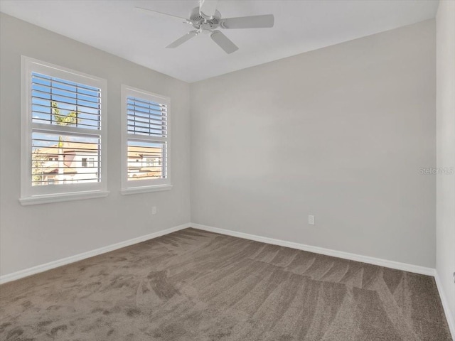 carpeted spare room with ceiling fan