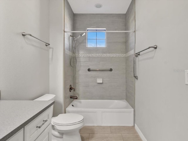 full bathroom with tiled shower / bath, vanity, and toilet