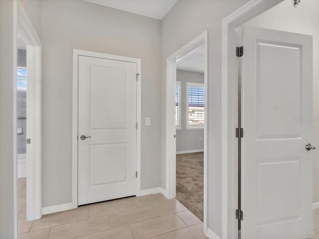 hallway featuring light carpet