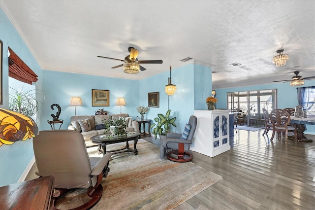 living room with hardwood / wood-style flooring, a textured ceiling, and ceiling fan