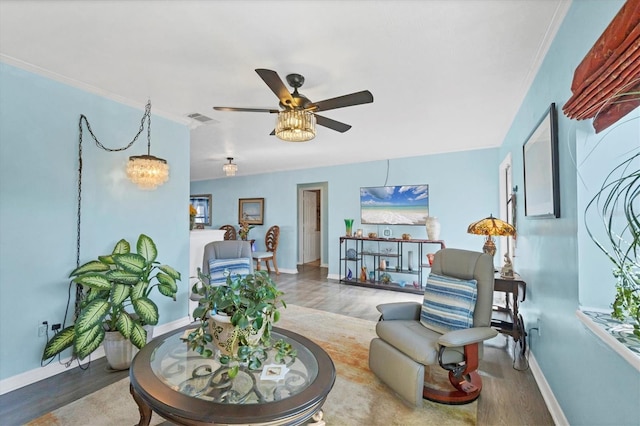 living room featuring ceiling fan, ornamental molding, and hardwood / wood-style floors