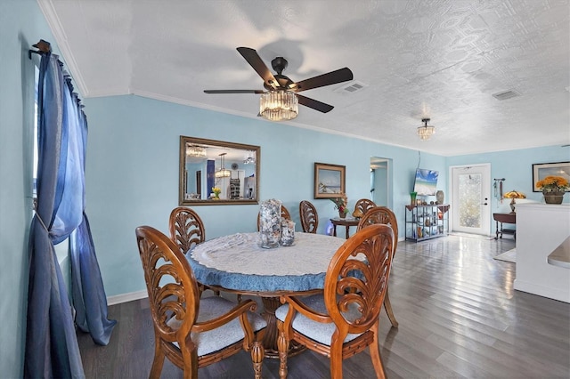 dining area featuring ornamental molding, dark hardwood / wood-style floors, ceiling fan, and a textured ceiling