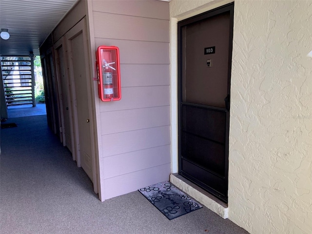 property entrance featuring stucco siding